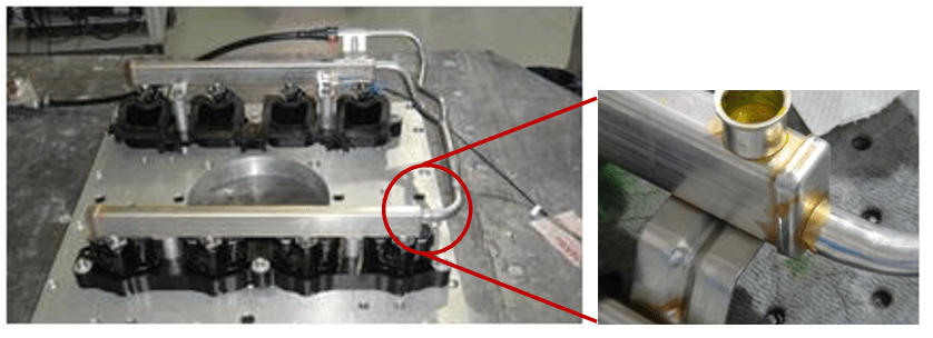 Figure 8. Engine Fuel-Rail System Showing Fatigue Failure at Crossover Pipe Joint